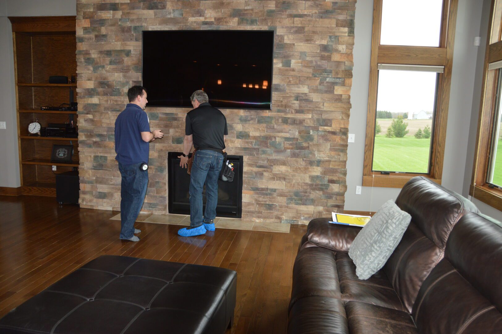 Two men inspecting the fireplace