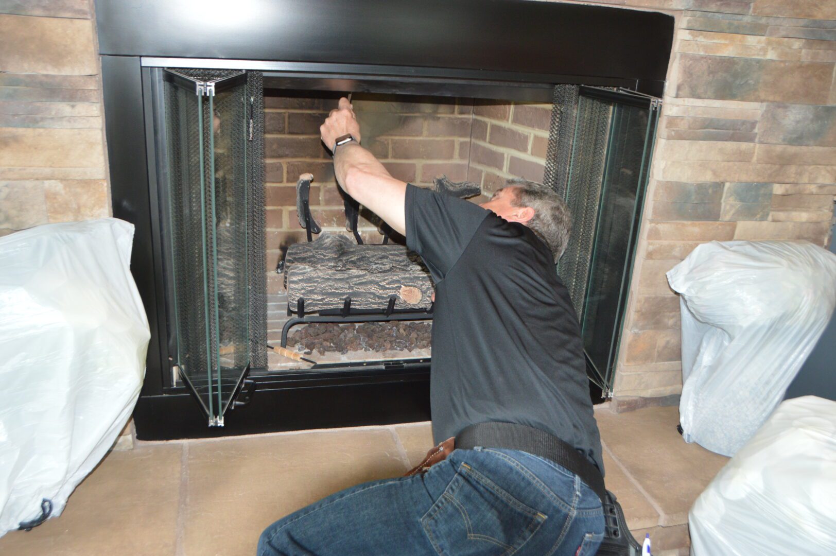 A man checking the fireplace
