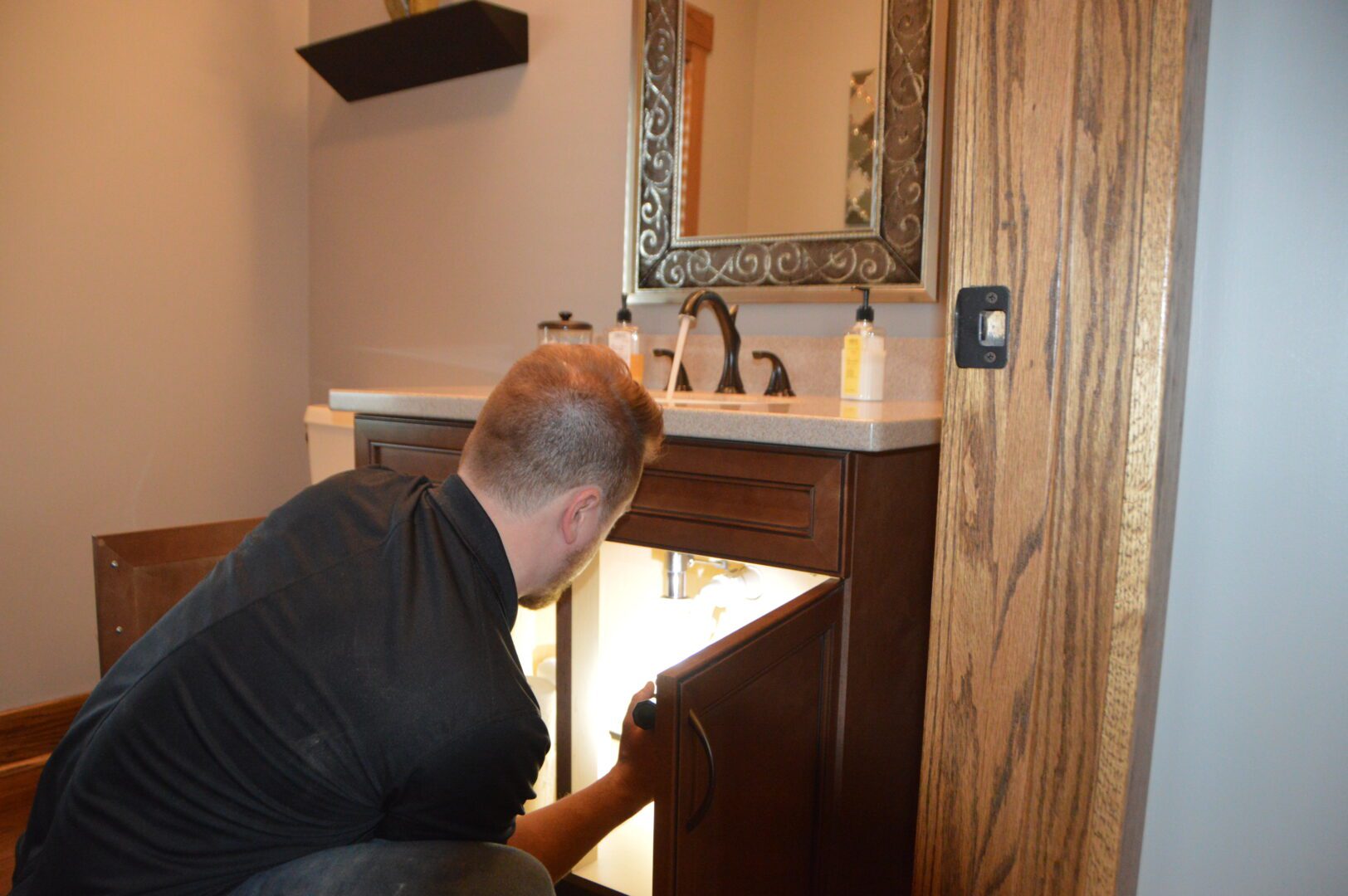A man inspecting plumbing