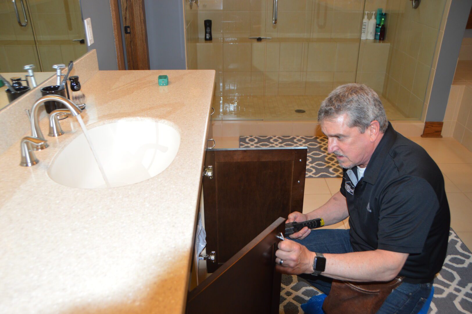 A man looking under the sink