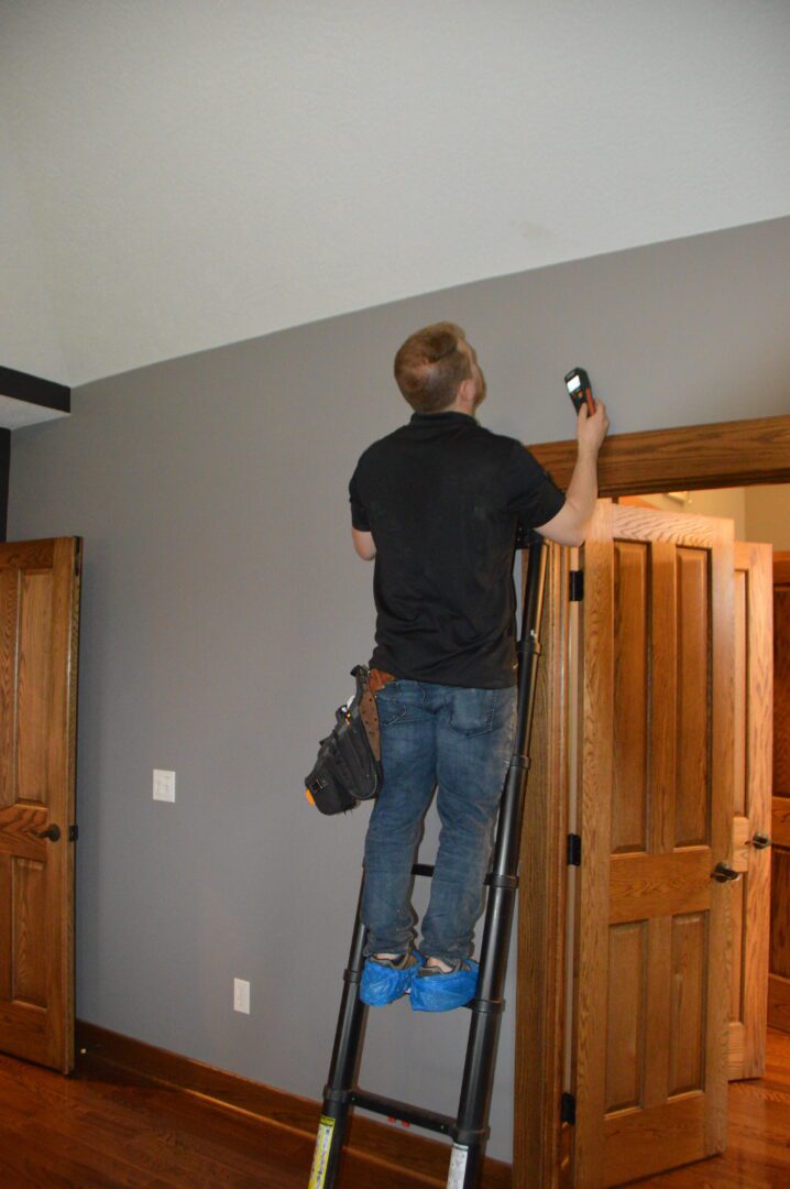 A man standing on a ladder